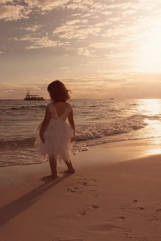 Silhouetted figure in flowing dress creates stunning beach photo using iPhone beach photography.