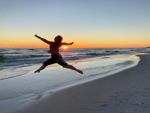 Silhouetted figure leaping joyfully, perfect for stunning beach photos with iPhone.